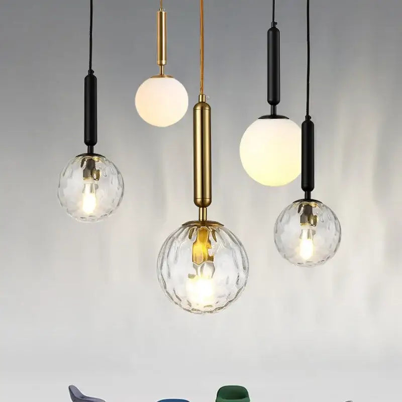 Modern brass and black glass ball pendant light with textured clear and frosted spherical shades for dining room decorbites glass ball pendant