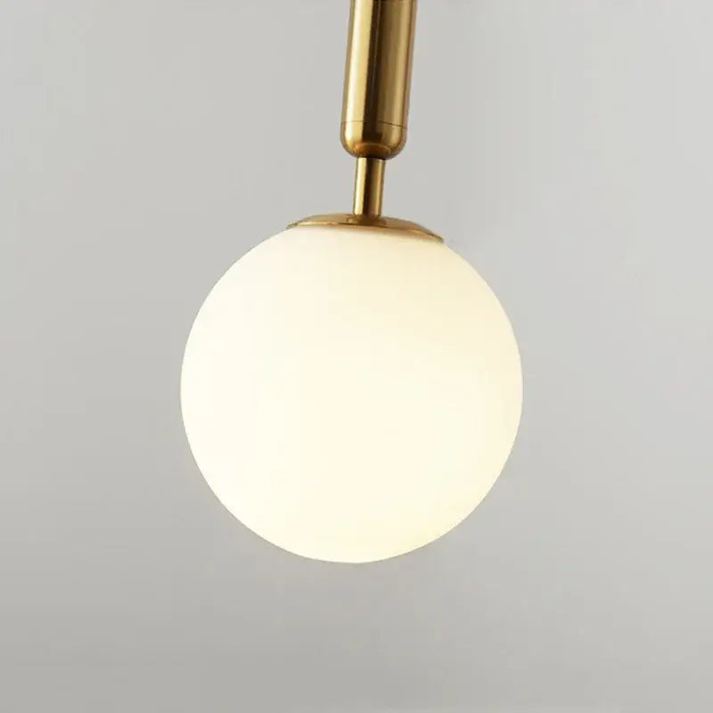A sleek modern brass and black glass ball pendant light with frosted glass globe for dining room decorbites glass ball