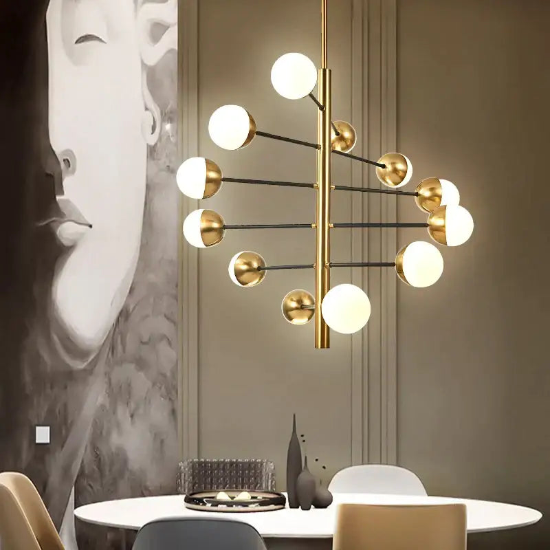 Modern brass and black glass bubble chandelier with gold-toned arms and white glass shades for dining room decorbites glass bubble