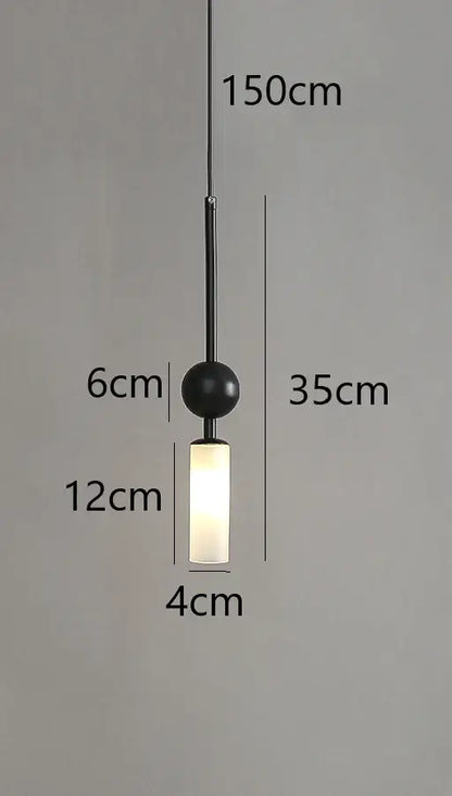 Black spherical pendant light with frosted glass cylinder and thin black cord in modern brass and black glass design style