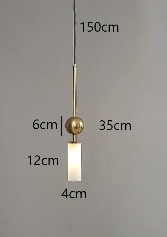 Modern brass pendant light with frosted glass cylinder and spherical top designed for dining room with led bulb
