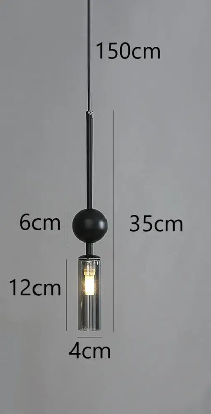Modern brass and black glass pendant light featuring a black spherical cord pendant with clear glass and led bulb housing