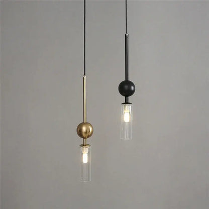 Modern brass and black glass pendant light with led bulbs and slender rods hanging from thin cords for dining room