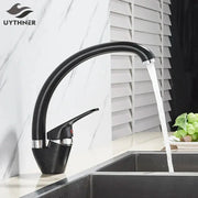 Modern brass black kitchen sink faucet with curved swivel spout featuring black speckled uythner design and chrome accents
