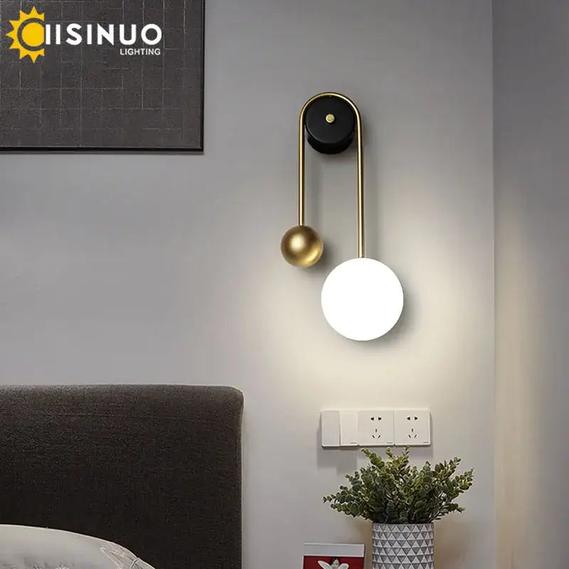 Modern brass and black led wall sconce with spherical light fixture for living room decorbites led wall sconce