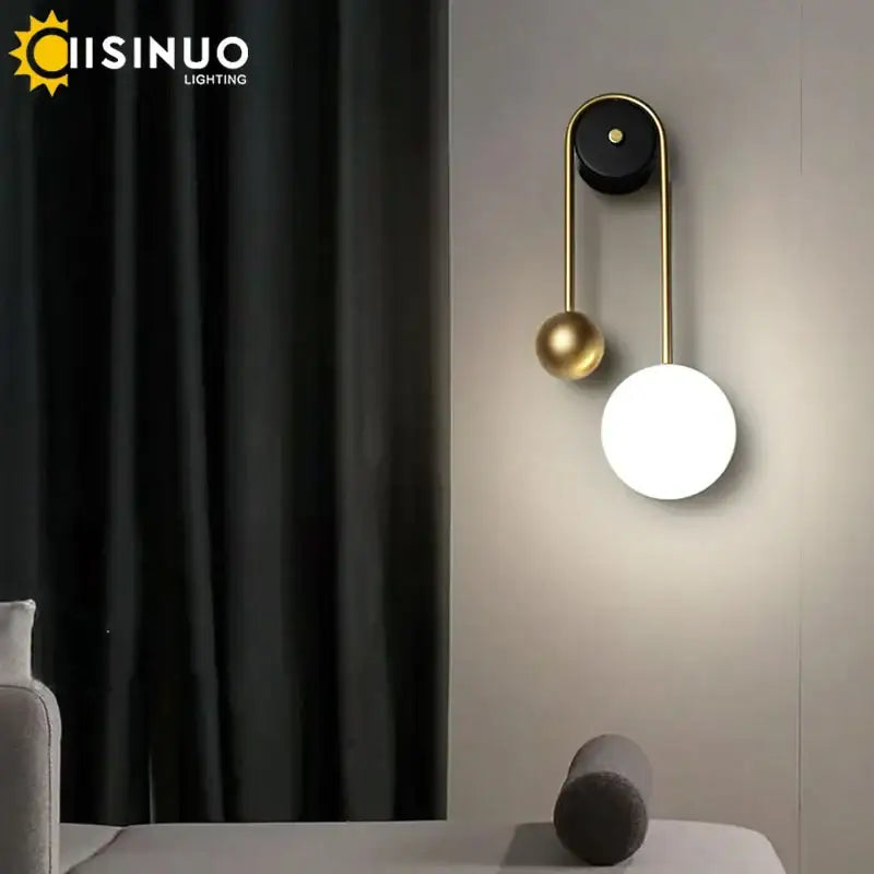Modern brass and black led wall sconce with sleek gold frame and two spherical shades for living room decorbites led wall light
