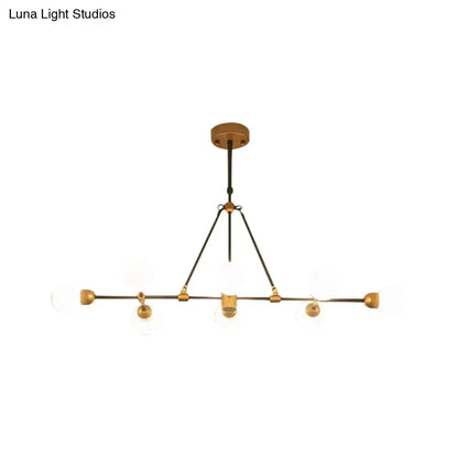 Decorbites brass finish island light with orb shade featuring clear glass globes and black metal for dining room use