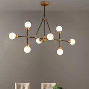 DecorBites™ brass finish island light with orb shade featuring six frosted glass globes for dining room use