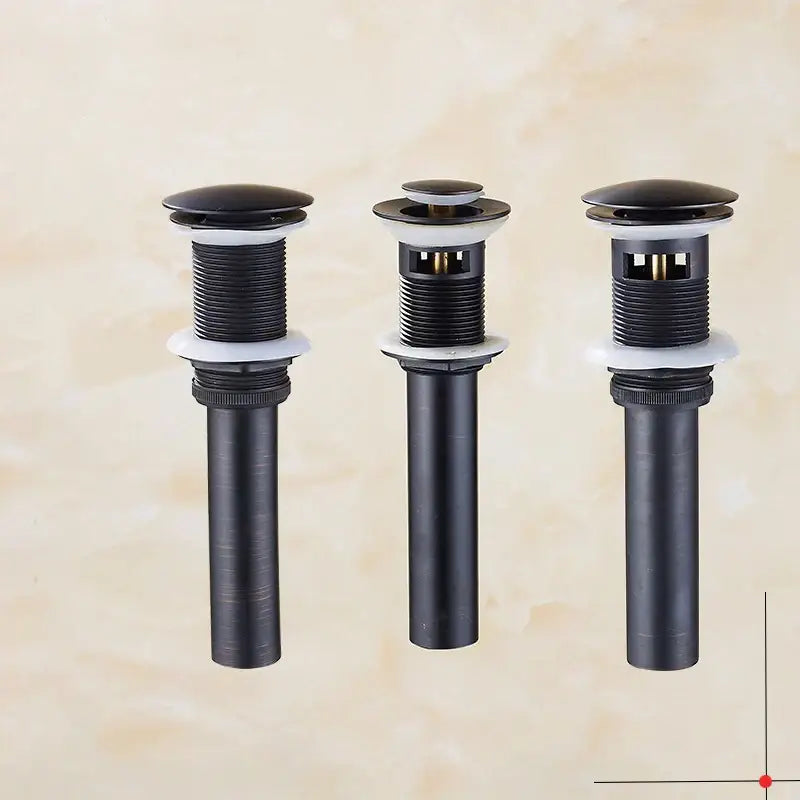 Three decorbites brass black pop up drain stoppers with black matte finish white seals and threaded metal bodies for bathrooms