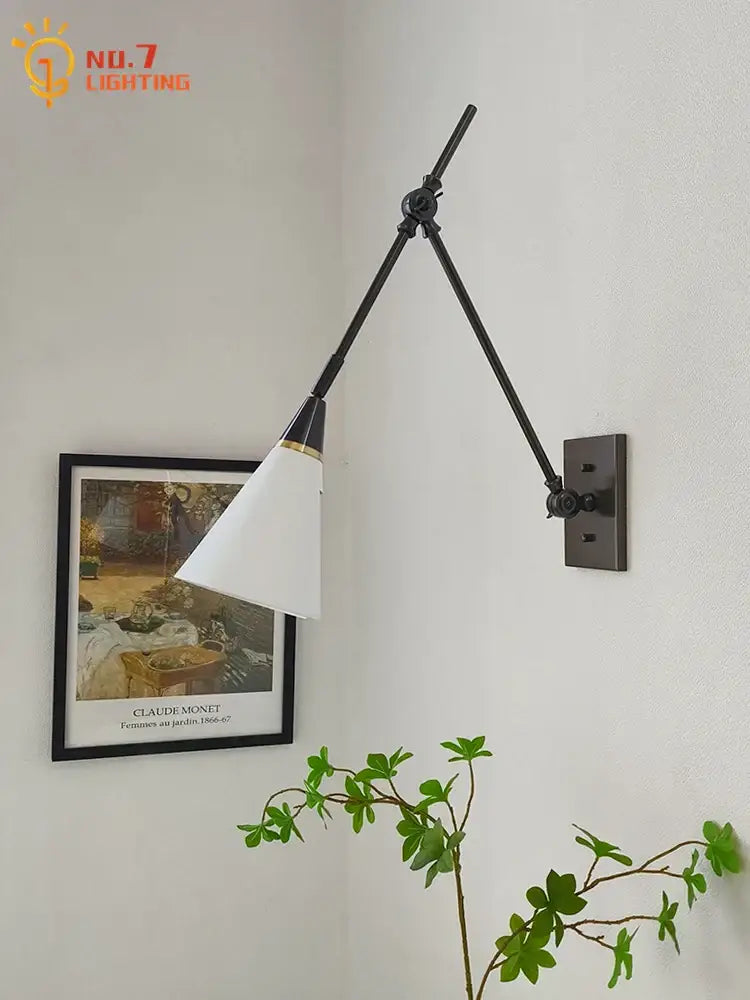 Black articulated wall lamp with white conical shade and gold trim from decorbites brass black collection
