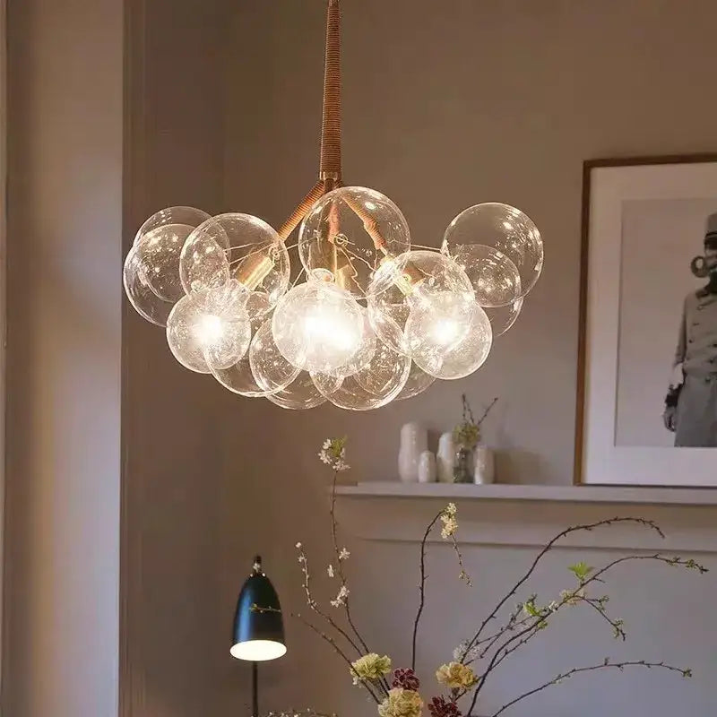 Modern brass bubble chandelier featuring glass bubbles brass-toned metal arms and woven cord suspension by decorbites bubble chandelier