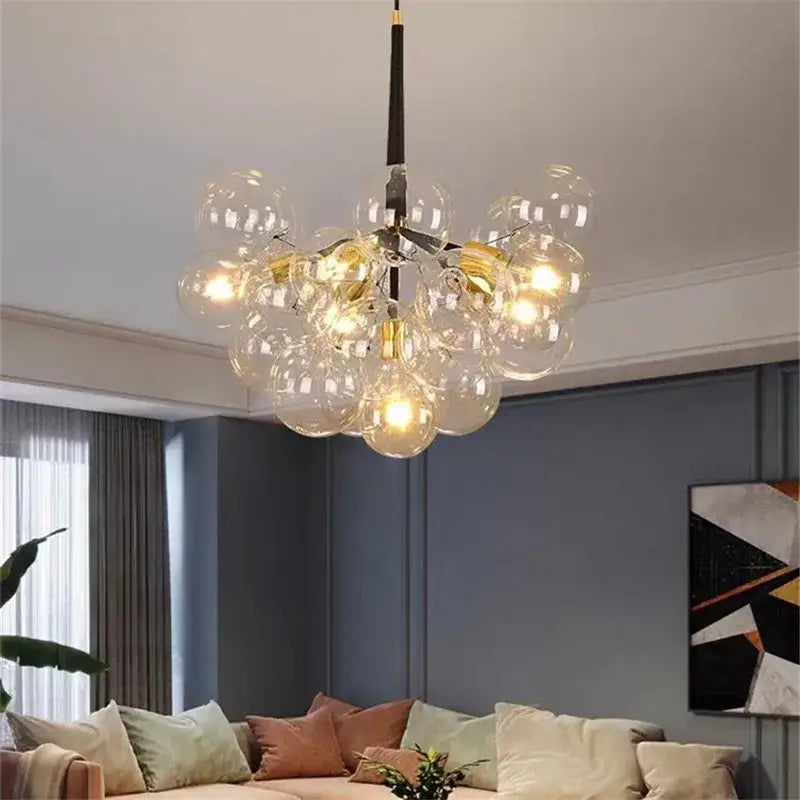 Modern brass bubble chandelier with glass bubbles warm glowing bulbs and black central rod for bedroom lighting decorbites bubble chandelier