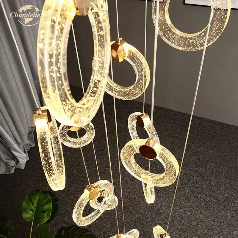 Modern brass bubble crystal LED chandelier featuring multiple translucent glowing rings with gold hardware for bedroom decorbites bubble crystal lighting