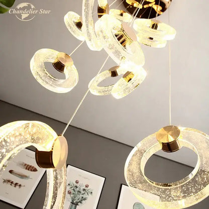 Modern brass bubble crystal led chandelier with translucent ring-shaped acrylic and gold-toned metallic accents for bedroom decorbites bubble crystal lighting