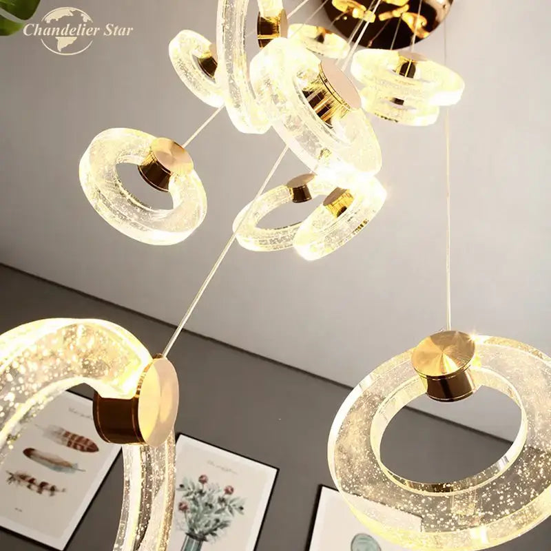 Modern brass bubble crystal led chandelier with translucent ring-shaped acrylic and gold-toned metallic accents for bedroom decorbites bubble crystal lighting