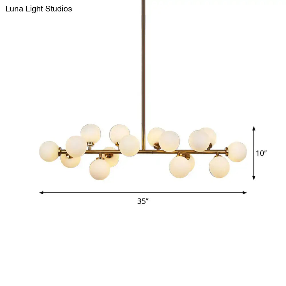 Modern brass bubbled island light fixture chandelier with frosted glass globe bulbs in a branching design for dining room