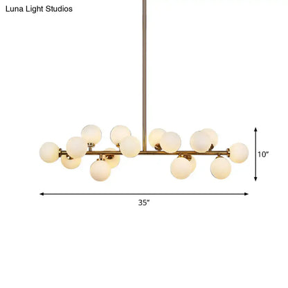 Modern brass bubbled island light fixture chandelier with frosted glass globe bulbs in a branching design for dining room