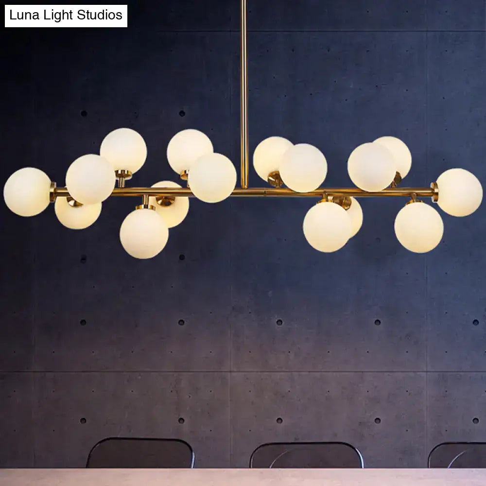 Modern brass bubbled island light fixture with gold-toned finish and frosted glass globes for dining room chandelier