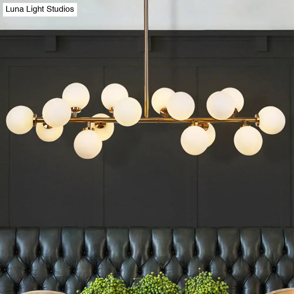 Modern brass bubbled island light fixture chandelier with gold-toned frame and frosted glass globe shades for dining room