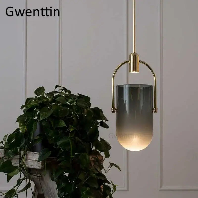 Gwenttin pendant lamp with brass-finished metal frame and gray to white bucket glass pendant shade for dining room