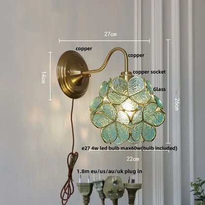 Modern brass butterfly wall sconce with brass copper finish and translucent teal flower-shaped clear glass shade by decorbites