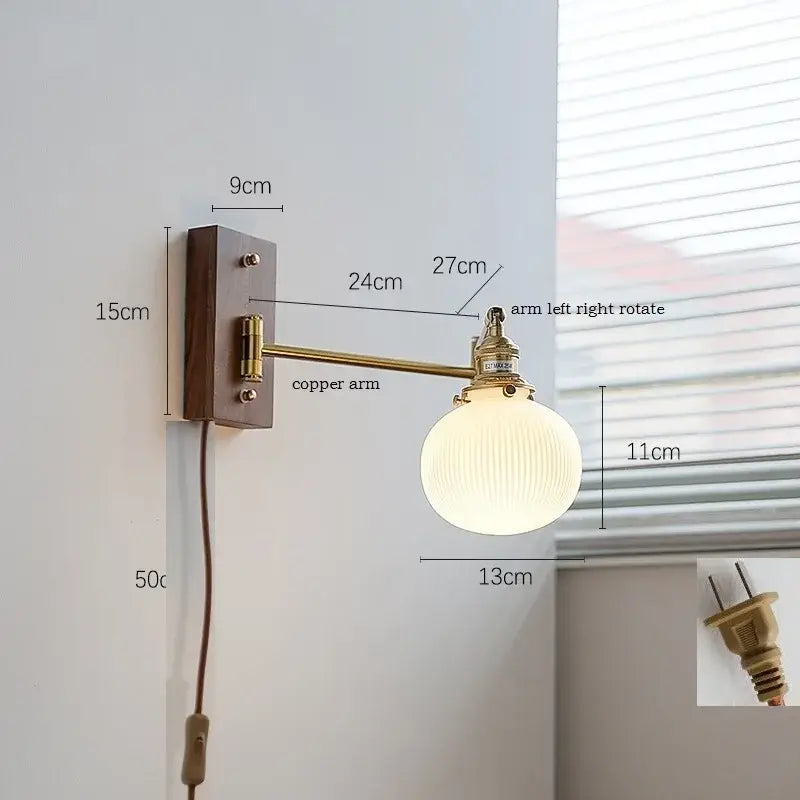 Vintage-style modern brass canopy led wall light with brass copper arm and ribbed off-white globe on dark wood plate