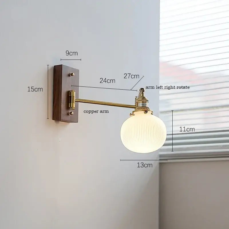 Modern brass canopy led wall light with brass copper arm dark wood backplate and off-white ribbed glass globe decorbites canopy led