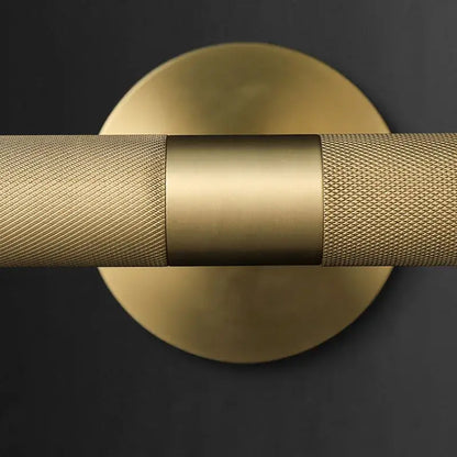 Modern brass copper mirror wall lamp with gold-toned textured cylindrical bar and smooth central band for bedroom decorbites brass copper