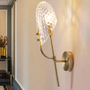 Modern brass crystal beveled light fixture hallway sconce with a delicate textured crystal lampshade and gold-toned metal arm and base