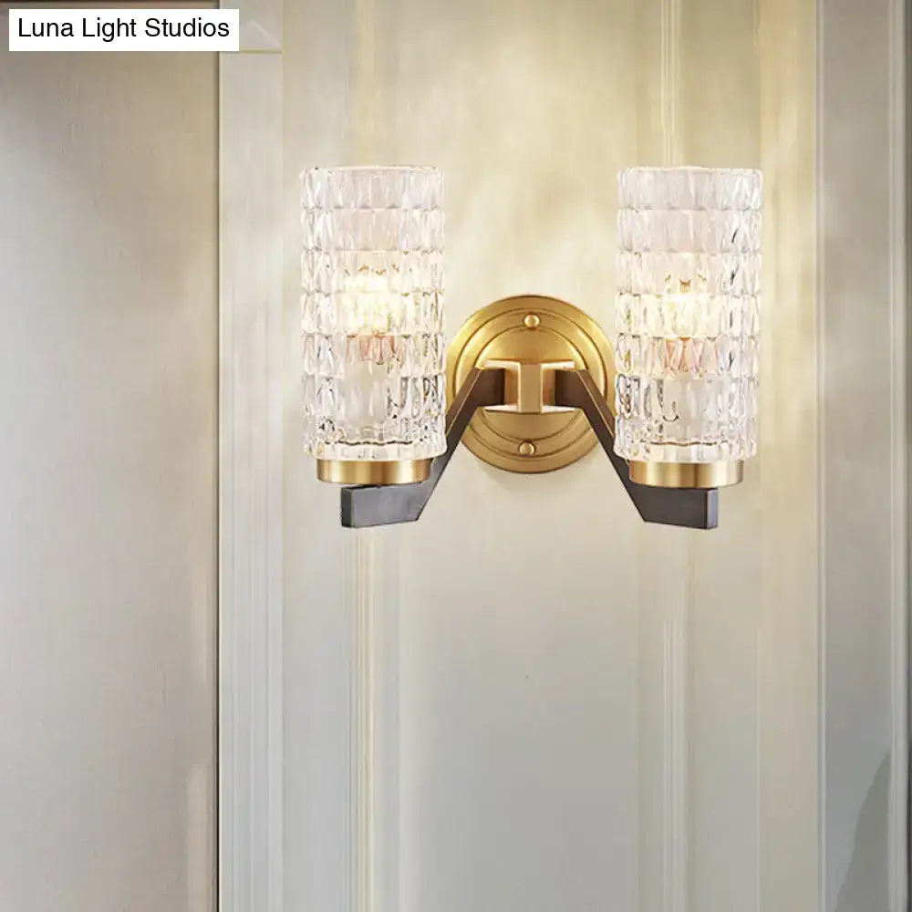 Modern brass flush wall sconce with gold-toned finish and two textured crystal glass shades for bedroom wall lamp