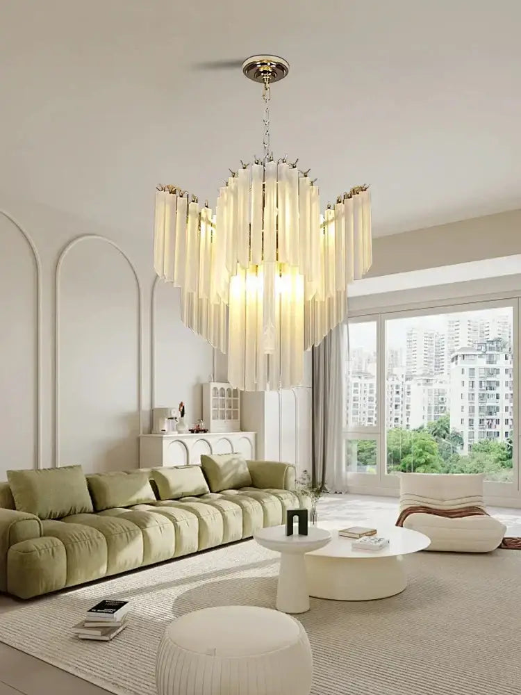 Modern brass crystal glass chandelier with translucent cream-colored cascading rods for elegant dining room decorbites crystal glass