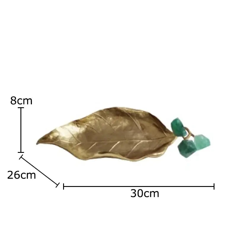 Gold-colored brass crystal grape leaf-shaped tray with green gemstone accent for modern living room sculpture
