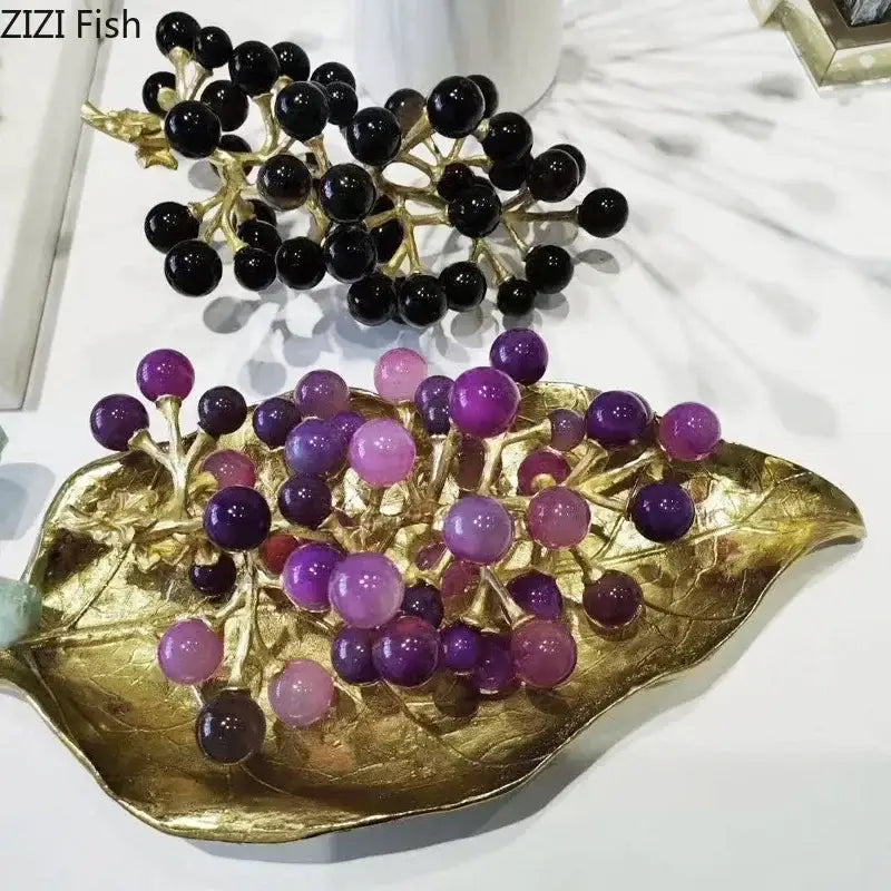 Golden leaf-shaped brass crystal grape ornaments tray holding black and purple translucent gemstone grapes sculpture