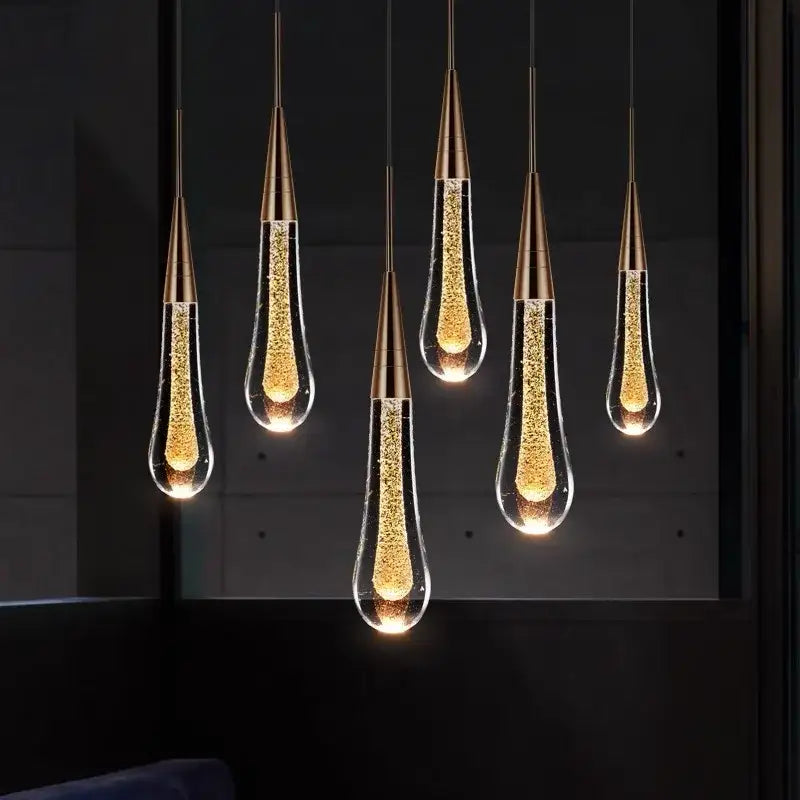 Six elegant brass crystal led teardrop pendant lights with glowing golden particles for modern dining room decorbites crystal led chandelier
