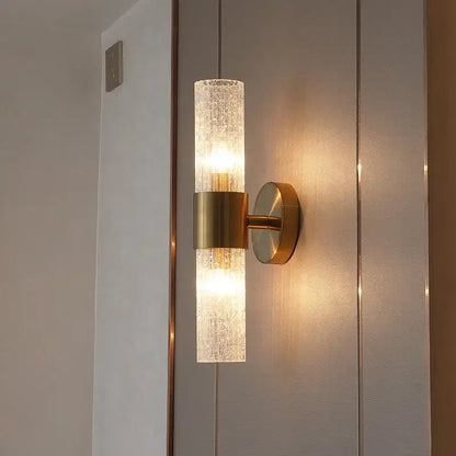 A modern brass crystal led wall lamp with a textured glass sconce diffusing warm light for bedroom decorbites crystal led