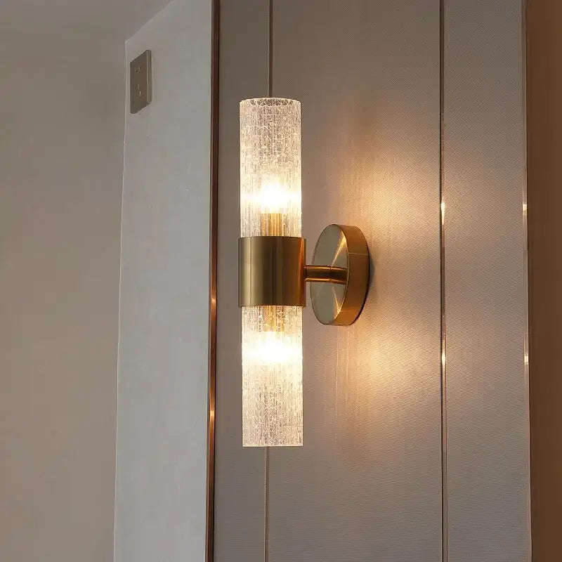 A modern brass crystal led wall lamp with a textured glass sconce diffusing warm light for bedroom decorbites crystal led