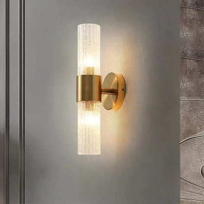 Gold-toned modern brass crystal led wall lamp with textured translucent glass cylinder and brushed brass accents for decorbites crystal led wall decor