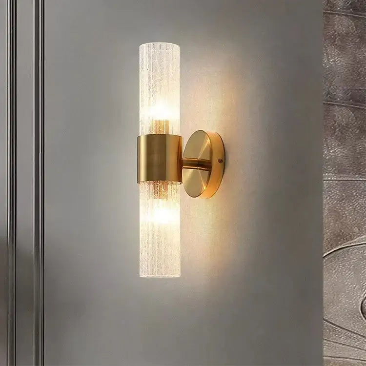 Gold-toned modern brass crystal led wall lamp with textured translucent glass cylinder and brushed brass accents for decorbites crystal led wall decor