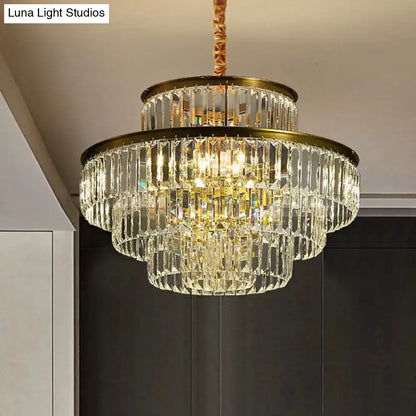 A multi-tiered crystal chandelier pendant light with gold-toned metal frame and hanging chain for living room decor