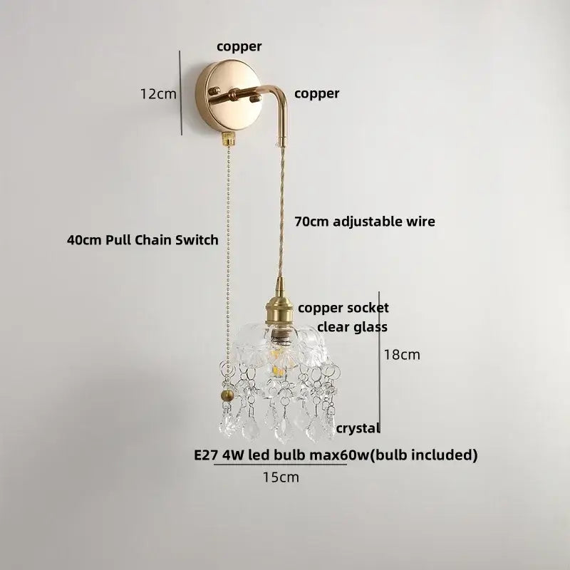 Modern brass crystal wall lamp with copper finish clear glass shade and dangling crystal droplets for bathroom mirror use