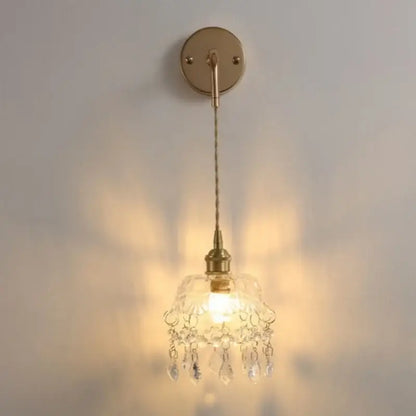 Modern brass crystal wall lamp featuring a delicate brass sconce with decorbites clear glass chandelier shade and teardrop crystals