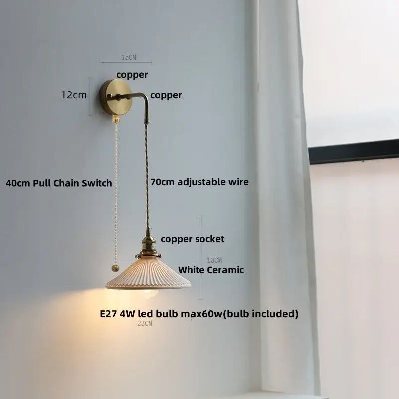 Modern brass crystal wall lamp with copper arm and adjustable wire suspending a white ceramic shade for decorbites clear glass