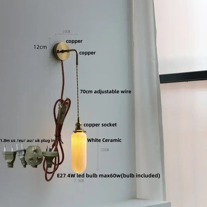 Modern brass crystal wall lamp featuring a warm glowing white ceramic pendant with clear glass ribbed shade decorbites clear glass
