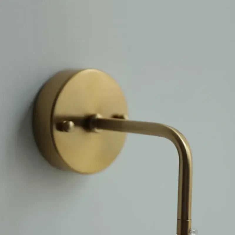 Modern brass cube led wall light with brass-finished curved arm and circular base for decorbites led wall lighting