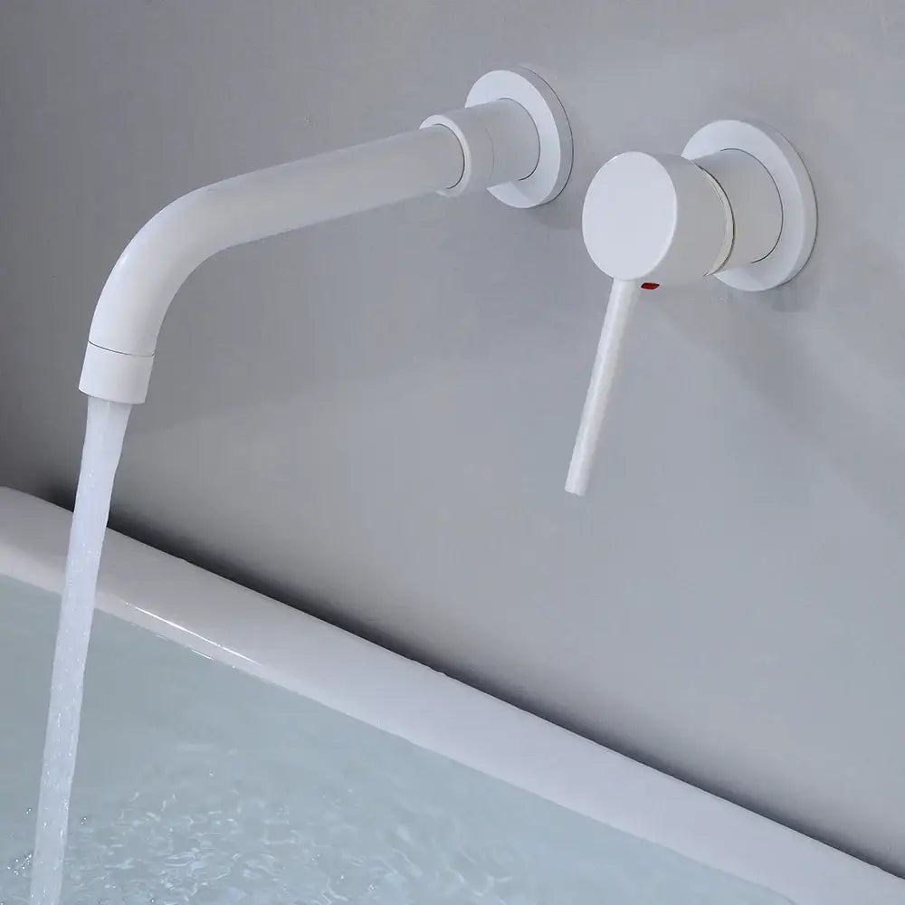 Modern white wall-mounted faucet with sleek curved spout and minimalist handle for bathroom use in brass finish