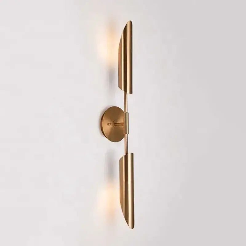 Modern brass cylindrical wall light with sleek elongated shades and minimalist circular base for decorbites golden luxury decor
