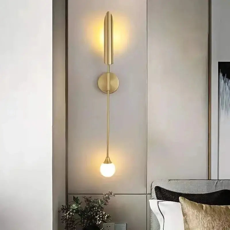 Modern brass cylindrical wall light with gold-toned minimalist design and frosted glass bulb for golden luxury wall decorbites wall light