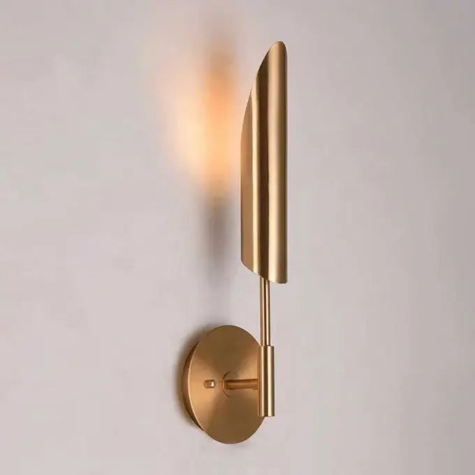 Modern brass cylindrical wall light with brushed gold finish and leaf-inspired design for golden luxury wall decorbites wall light