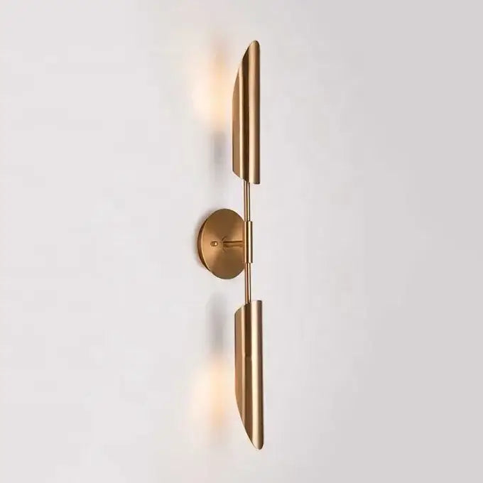 Modern brass cylindrical wall light with sleek elongated leaf-shaped shades on a minimalist base for golden luxury wall decorbites