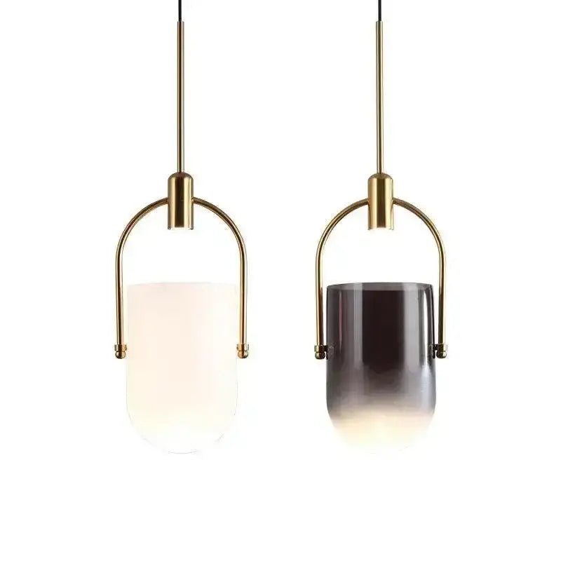 Two modern decorbites bucket chandelier pendant lights with brass metal frames and frosted white and dark gray glass shades